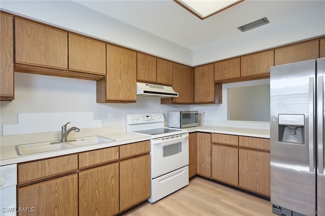 kitchen with light hardwood / wood-style flooring, sink, and appliances with stainless steel finishes