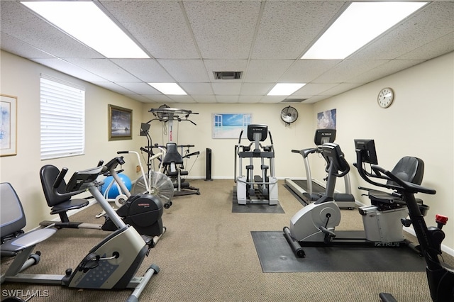 gym with a paneled ceiling