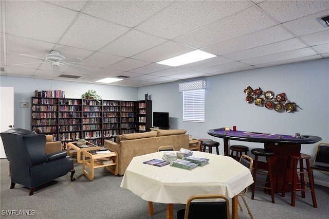 playroom with carpet floors, a drop ceiling, visible vents, and a ceiling fan