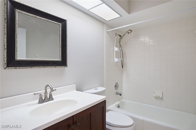 full bathroom featuring toilet, tiled shower / bath combo, and vanity