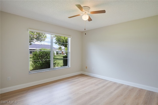 unfurnished room featuring a textured ceiling, ceiling fan, and light wood-type flooring