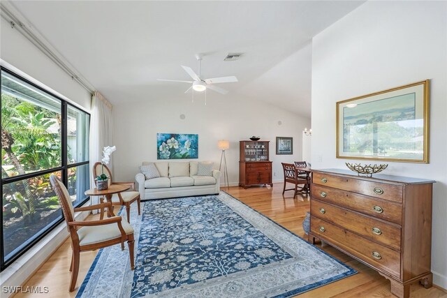 living room featuring lofted ceiling, ceiling fan, and hardwood / wood-style flooring