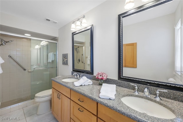 bathroom featuring tile patterned flooring, an enclosed shower, vanity, and toilet