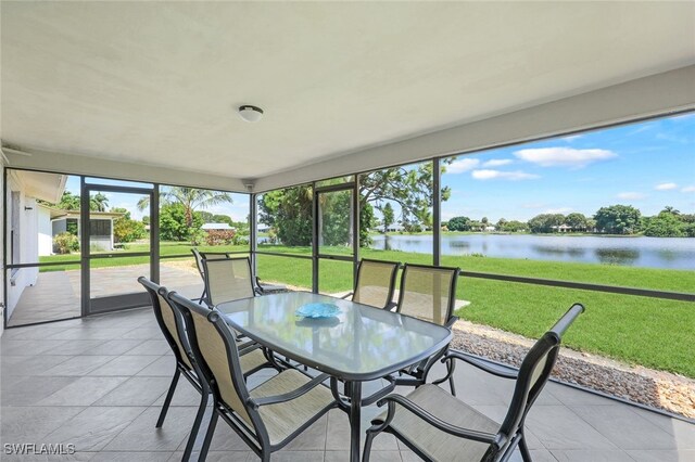 sunroom / solarium with a water view