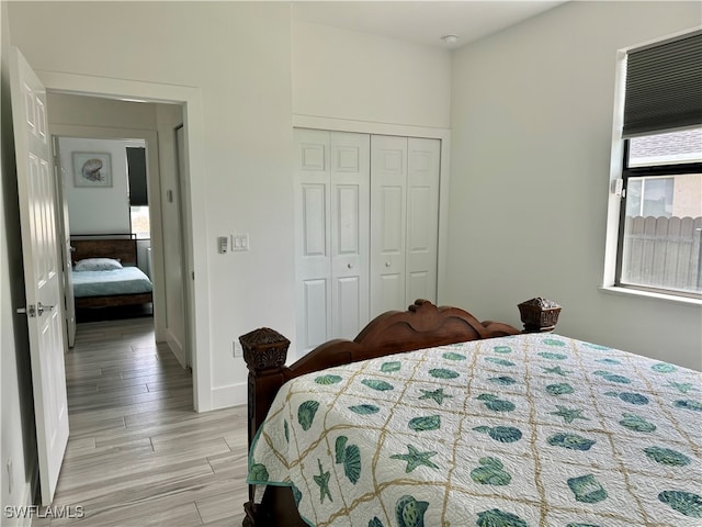 bedroom featuring light hardwood / wood-style flooring and a closet