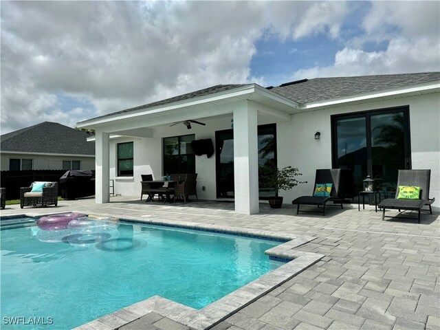 view of pool featuring ceiling fan, a patio area, and an outdoor hangout area