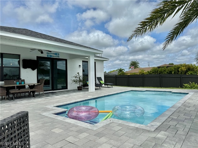 view of pool featuring a patio area, ceiling fan, and a hot tub