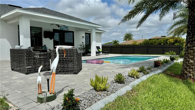 view of swimming pool with a patio and ceiling fan