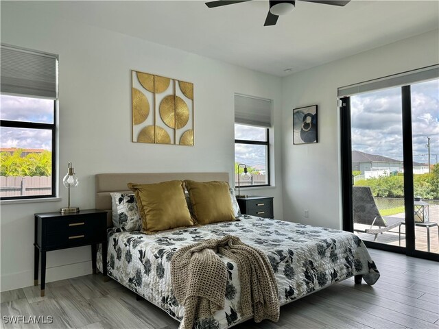 bedroom featuring ceiling fan, hardwood / wood-style flooring, and access to exterior