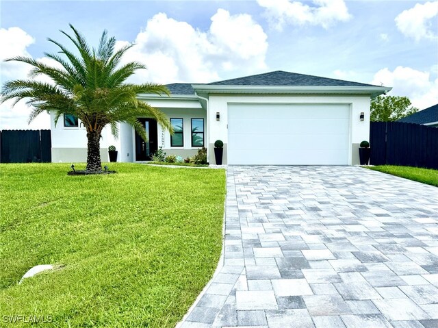 view of front of property featuring a front lawn and a garage