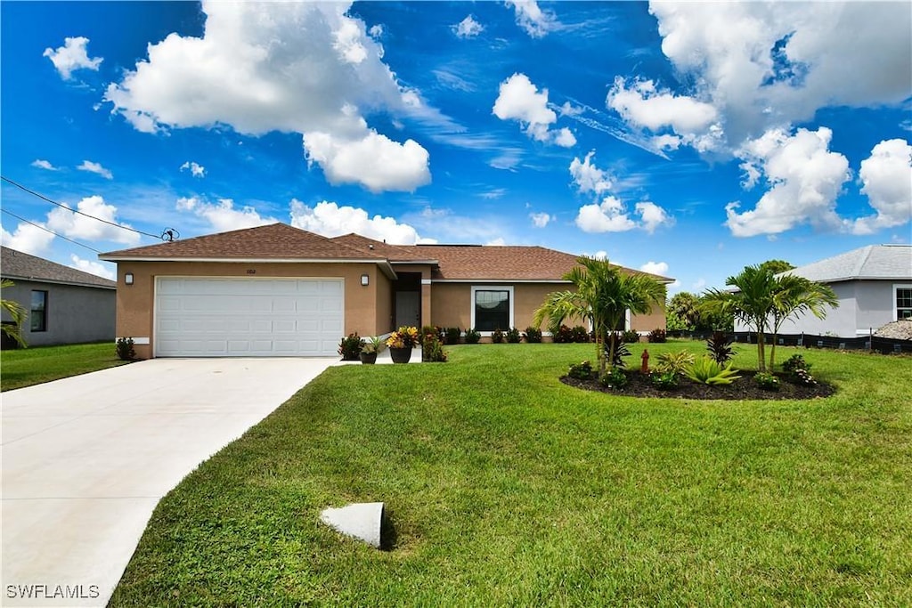 single story home featuring a garage and a front yard