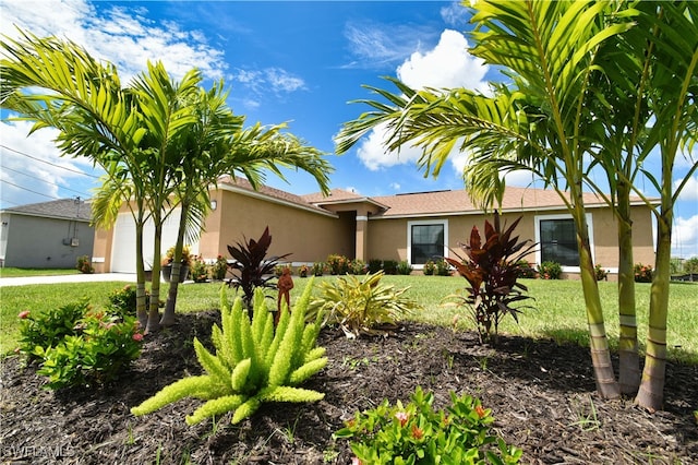 view of front facade with a garage and a front yard