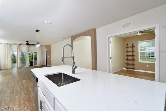 kitchen with ceiling fan, hanging light fixtures, plenty of natural light, and sink