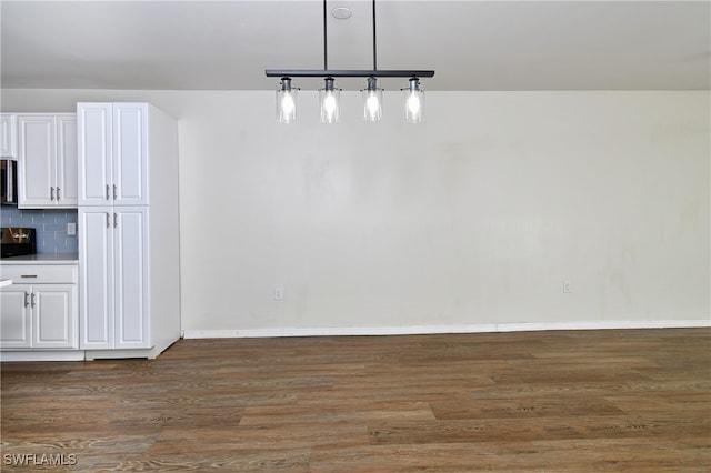 unfurnished dining area with dark hardwood / wood-style floors