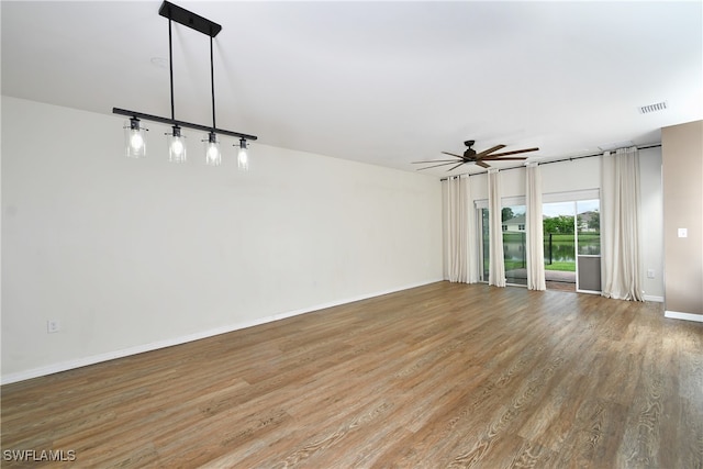 spare room with wood-type flooring and ceiling fan