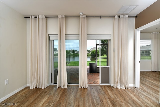 interior space featuring a water view and hardwood / wood-style floors