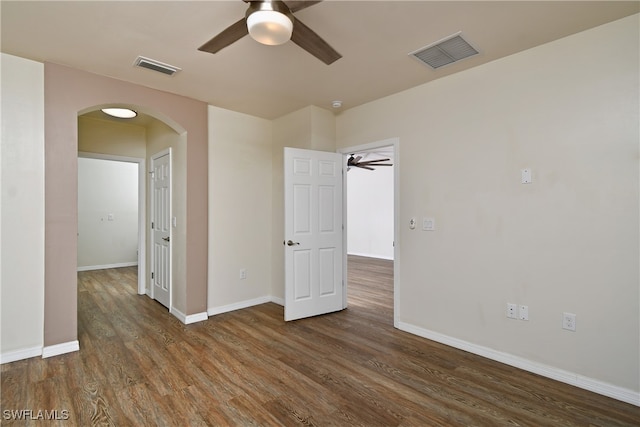 unfurnished bedroom featuring ceiling fan and dark hardwood / wood-style floors