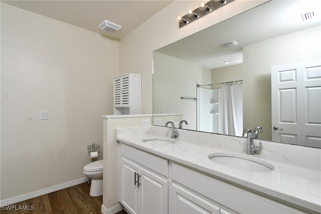 bathroom with walk in shower, toilet, hardwood / wood-style flooring, and vanity