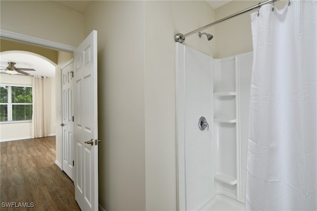 bathroom featuring ceiling fan, hardwood / wood-style flooring, and walk in shower