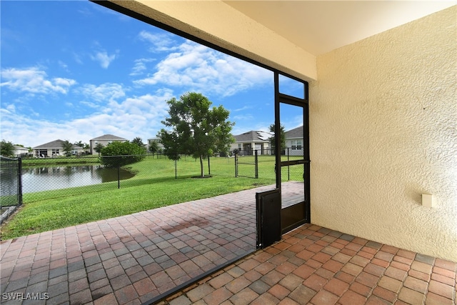 unfurnished sunroom with a water view