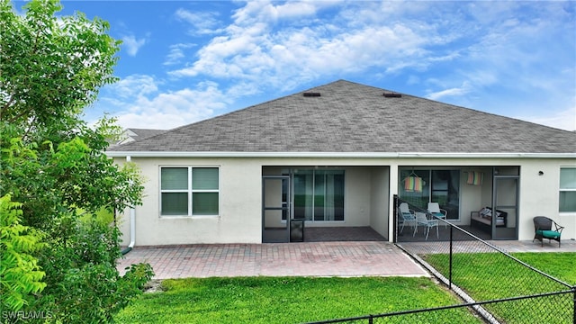 back of house featuring a yard and a patio