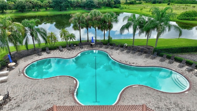 view of swimming pool with a water view and a patio