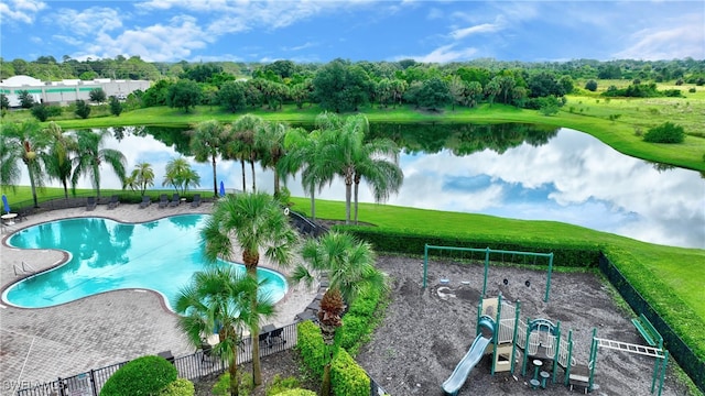 view of pool with a playground and a water view