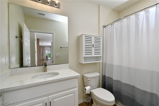 bathroom with a shower with shower curtain, toilet, and vanity