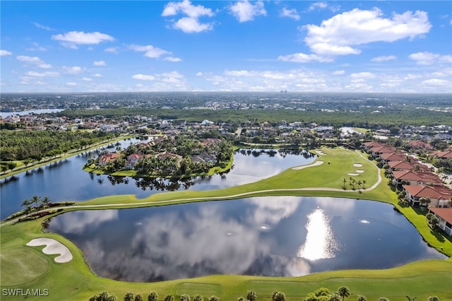 drone / aerial view featuring view of golf course and a water view