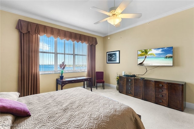 bedroom featuring ornamental molding, light carpet, ceiling fan, and baseboards