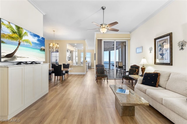 living room with ceiling fan with notable chandelier, ornamental molding, light wood-type flooring, and baseboards