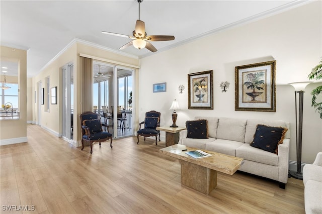 living room featuring a ceiling fan, light wood-style flooring, baseboards, and crown molding