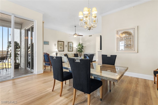 dining space with ornamental molding, light wood finished floors, ceiling fan with notable chandelier, and baseboards