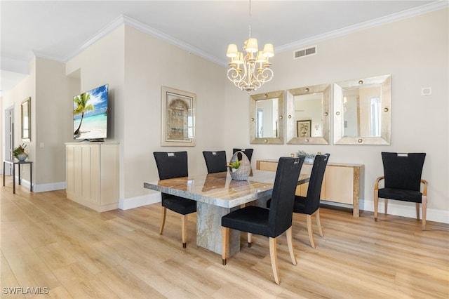 dining room featuring crown molding, an inviting chandelier, and light hardwood / wood-style floors