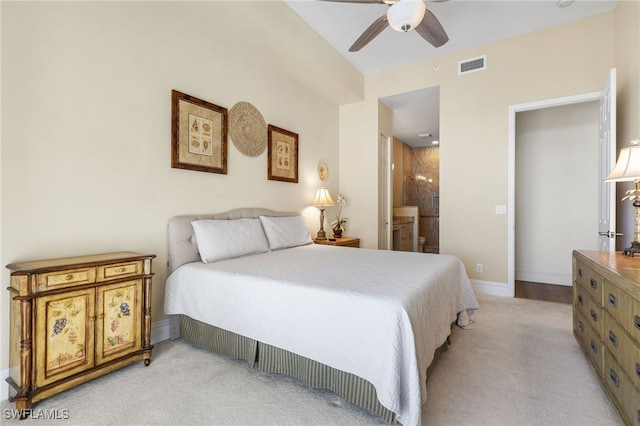 bedroom with light carpet, baseboards, visible vents, and connected bathroom