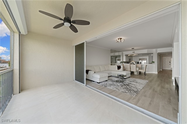 living room with ceiling fan and wood-type flooring