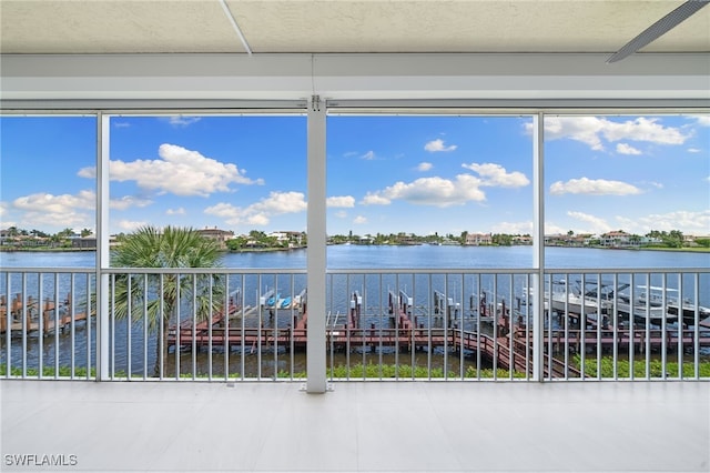 unfurnished sunroom with a water view