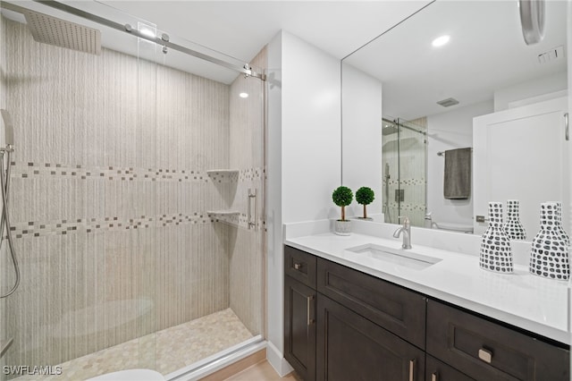 bathroom with an enclosed shower and vanity