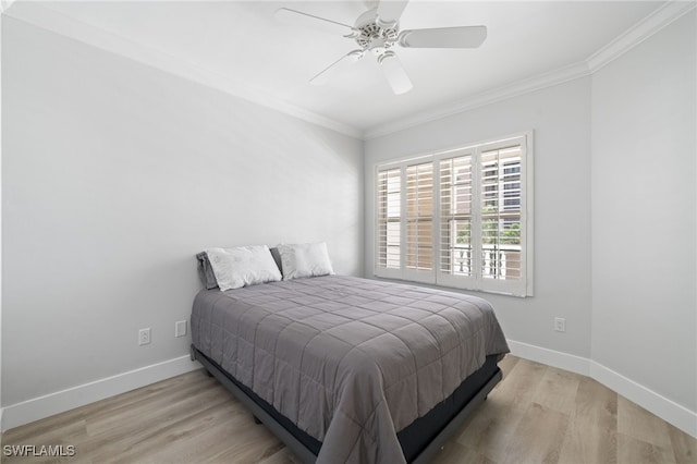 bedroom with light wood-type flooring, ornamental molding, and ceiling fan