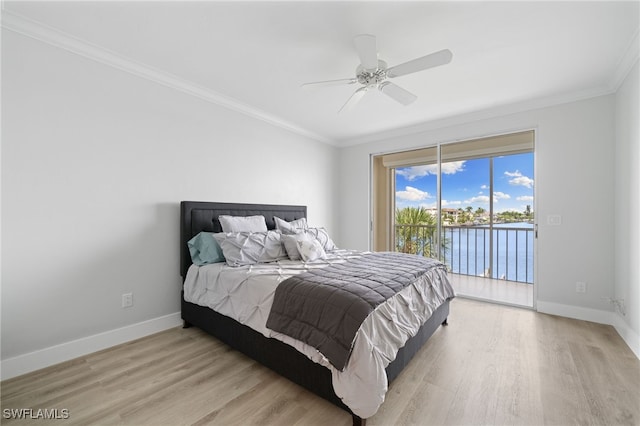 bedroom featuring light wood-type flooring, a water view, crown molding, access to exterior, and ceiling fan