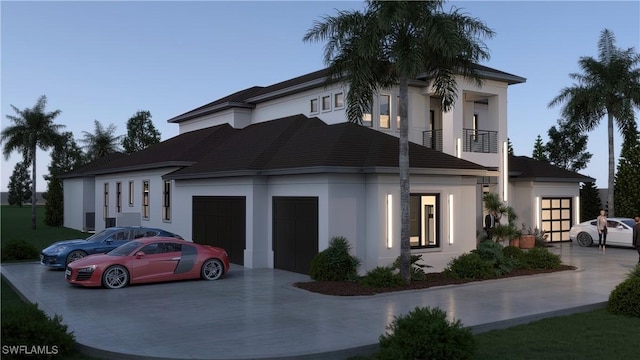 view of front of property featuring a balcony, a garage, driveway, and stucco siding