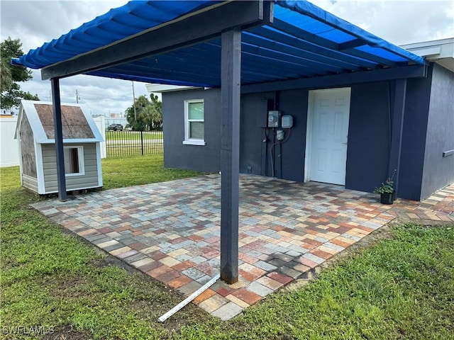 view of patio / terrace featuring an outbuilding, a storage shed, and fence