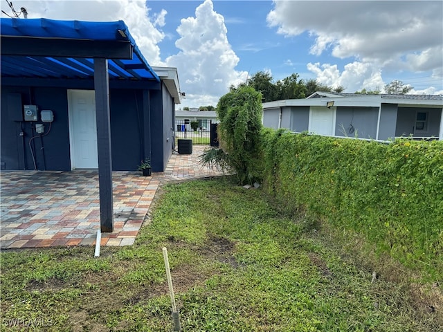 view of yard featuring a carport and central air condition unit