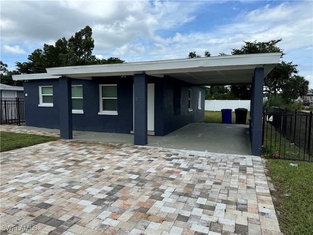 view of front of property featuring a carport