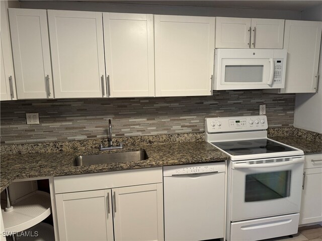 kitchen featuring white appliances, sink, and white cabinets