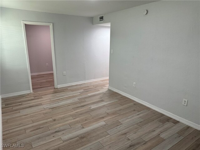 empty room with light hardwood / wood-style flooring