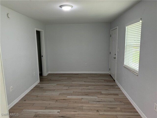 unfurnished room with light hardwood / wood-style floors