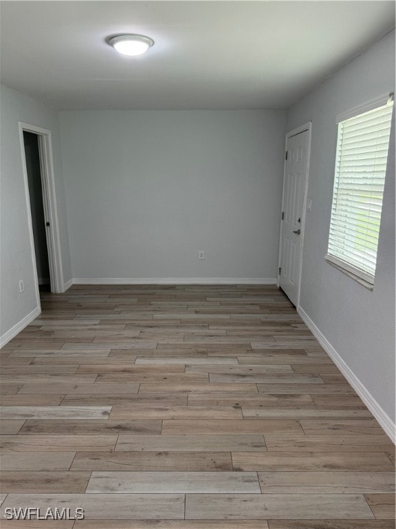 empty room with light hardwood / wood-style floors