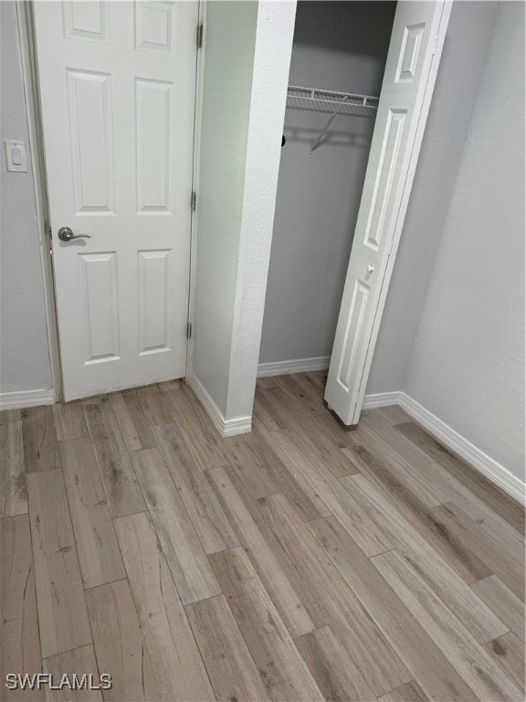 unfurnished bedroom featuring light wood-type flooring