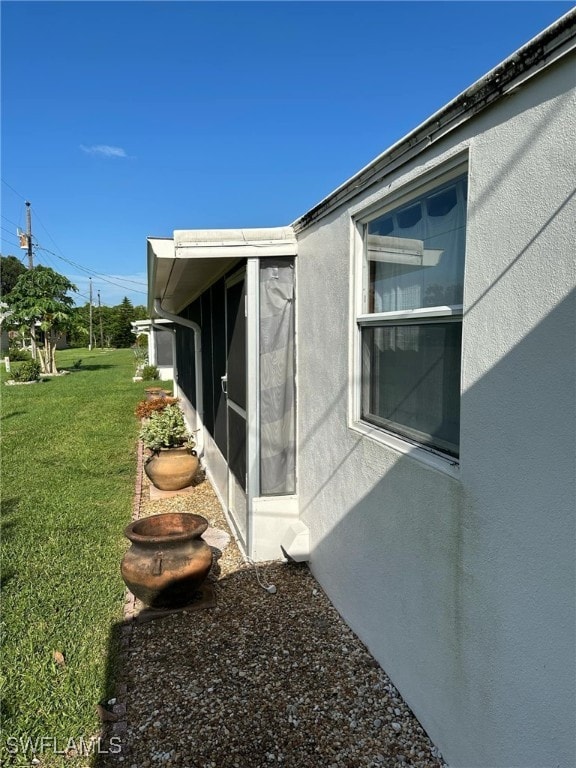 view of side of property featuring a yard